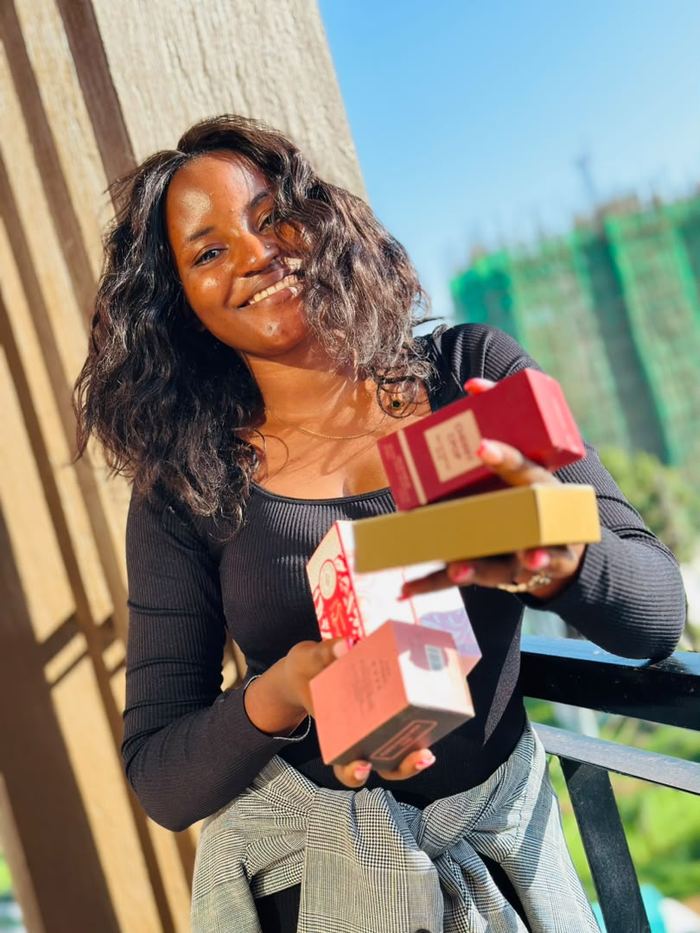 Tabitha holding gift-boxed perfumes